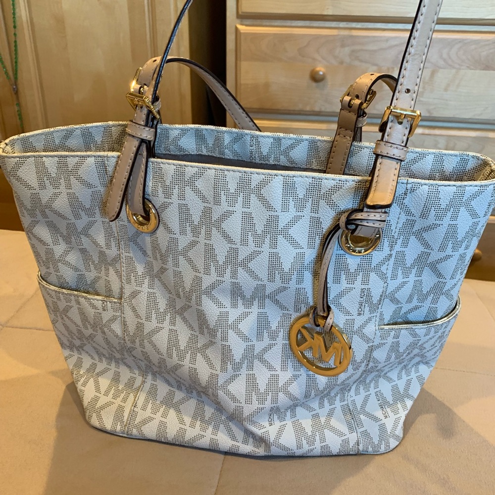 Authentic Michael Kors bag.  It’s not new used occasionally.